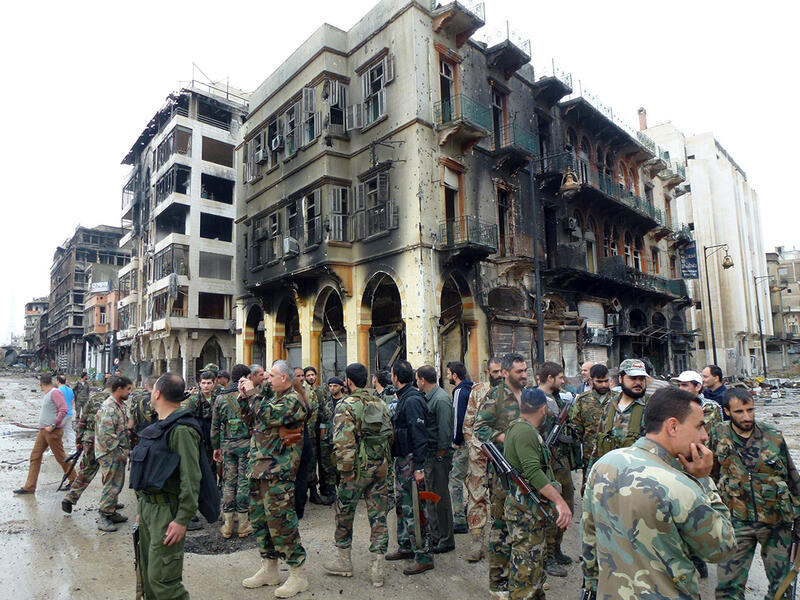 Syrian Arab Army soldiers stand in the streets of Homs. (AFP/File)