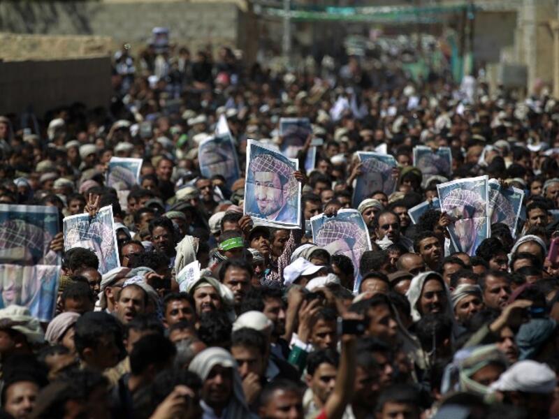 Supporters of the Shia Houthi movement hold portraits senior Houthi leader Lutf al-Quhom, who was killed in recent fighting, during his funeral on Feb. 18, 2016 in the capital Sanaa. (AFP/Mohammed Huwais)