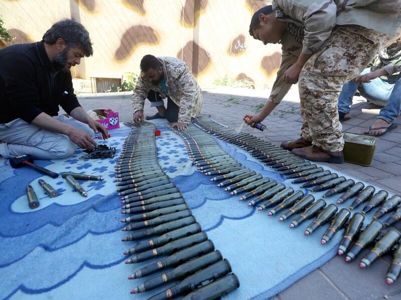 Fighters from a Misrata armed group loyal to the internationally recognised Libyan GNA prepare their ammunition before heading to the frontline as battles against Forces of Libyan strongman Khalifa Haftar continue on the outskirts of the capital Tripoli on April 9, 2019. Mahmud TURKIA / AFP