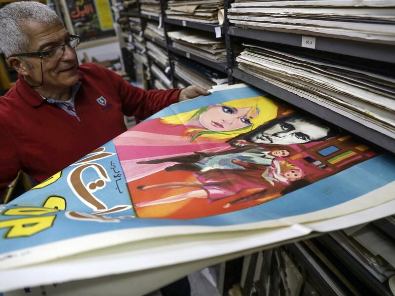 Abboudi Abu Jawdeh shows part of his vintage cinema poster collection at his office in the Lebanese capital Beirut  JOSEPH EID / AFP