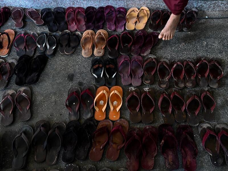 Footwear is seen as Buddhist monks, nuns, and members from the ultra-nationalist group Buddha Dhamma Parahita Foundation, previously known as Ma Ba Tha, attend the group's annual meeting in Yangon on June 17, 2019.  Ye Aung THU / AFP