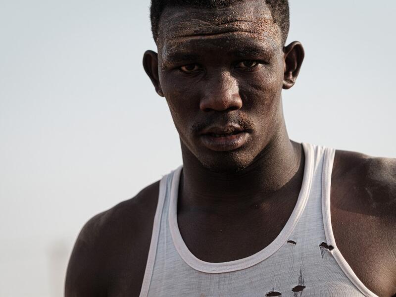 A Sudanese wrestler reacts during a traditional Nuba wrestling match at the Haj Youssef stadium in the district of Khartoum.  Yasuyoshi CHIBA / AFP