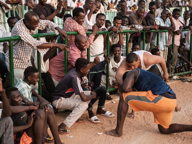 A Sudanese wrestler reacts after winning during a traditional Nuba wrestling match at the Haj Youssef stadium in the district of Khartoum.  Yasuyoshi CHIBA / AFP