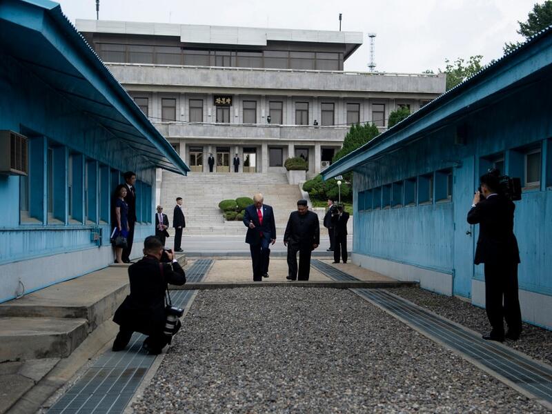 North Korea's leader Kim Jong Un stands with US President Donald Trump north of the Military Demarcation Line that divides North and South Korea, in the Joint Security Area (JSA) of Panmunjom in the Demilitarized zone (DMZ) on June 30, 2019.  Brendan Smialowski / AFP