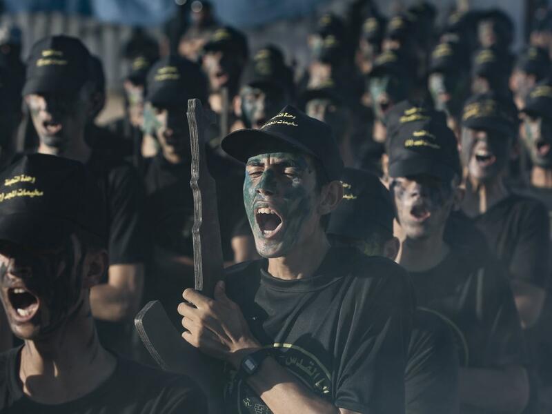 A Palestinian youth, carrying a wooden rifle, chants slogans during a military-style graduation ceremony organised by the Islamic Jihad movement in Gaza City on July 4, 2019.  MOHAMMED ABED / AFP