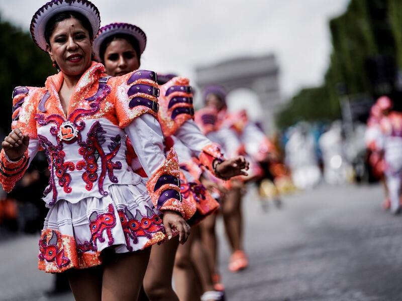 People parade during the Tropical Carnival on July, 7 2019 in Paris.  Kenzo TRIBOUILLARD / AFP
