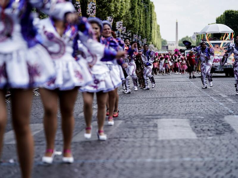 People parade during the Tropical Carnival on July, 7 2019 in Paris.  Kenzo TRIBOUILLARD / AFP