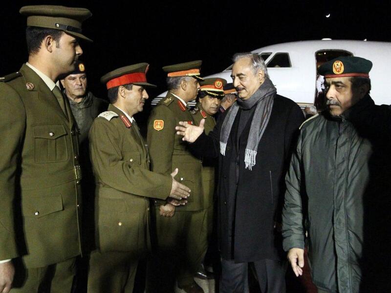 Khalifa Haftar, second from right, the military leader of the so-called Libyan National Army, is greeted after a trip to Russia /AFP