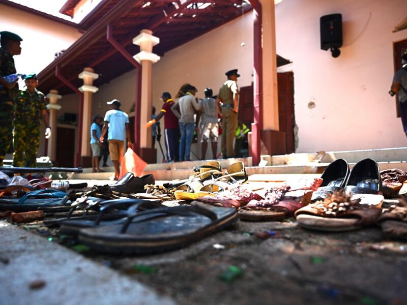 Shoes of victims are kept as evidence as security personnel inspect the interior of St Sebastian's Church in Negombo on April 22, 2019, a day after the church was hit in series of bomb blasts targeting churches and luxury hotels in Sri Lanka. Jewel SAMAD / AFP