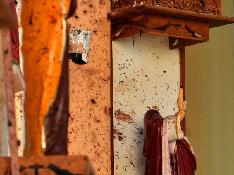 Broken statues are pictured next to shrapnel marks at St. Sebastian's Church in Negombo on April 22, 2019. ISHARA S. KODIKARA / AFP