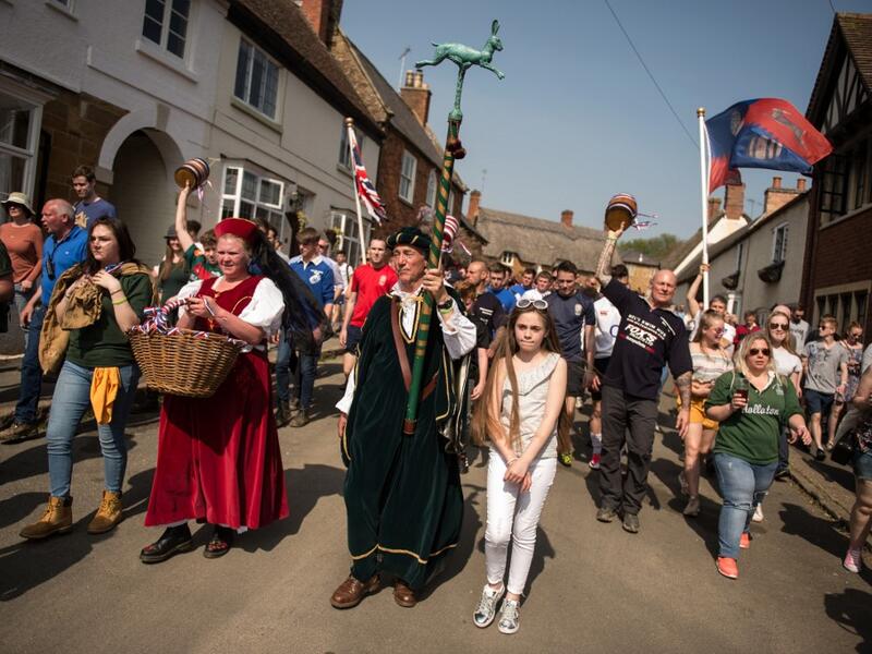 Teams from the villages of Hallaton and Medbourne process to the start point to fight over the 'bottles' (wooden casks) during the Easter Monday Hallaton Hare Pie Scrambling and Bottle Kicking traditional event in the village of Hallaton in central England on April 22, 2019.  Oli SCARFF / AFP