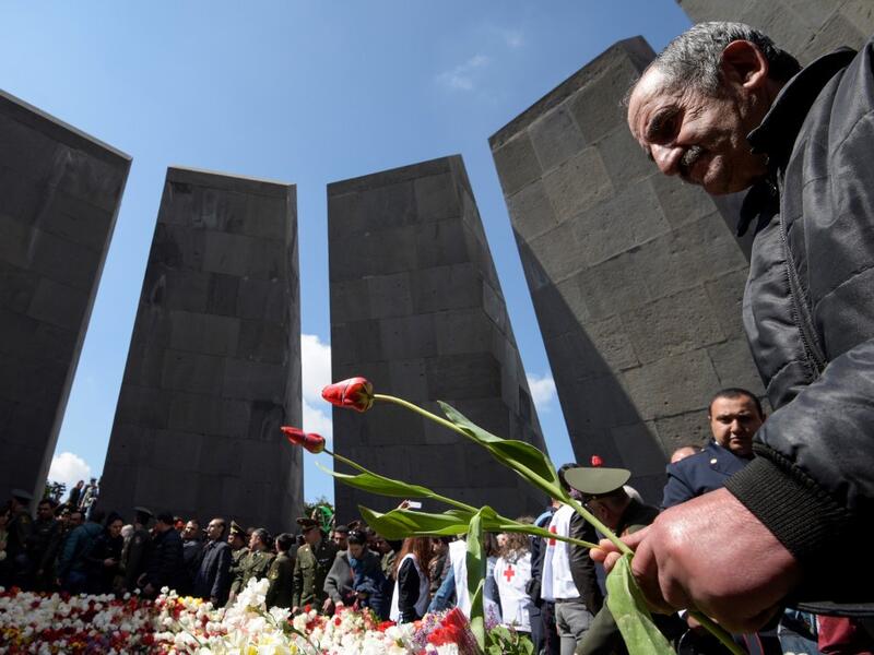 People attend a ceremony commemorating the 104th anniversary of the massacre of 1.5 million of Armenians by Ottoman forces in 1915, at the Tsitsernakaberd memorial in Yerevan on April 24, 2019.  KAREN MINASYAN / AFP
