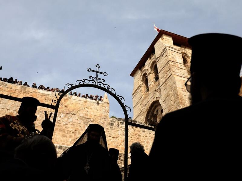 Greek Orthodox priests participate in the traditional Washing of the Feet ceremony in front of the church of the Holy Sepulchre, in Jerusalem's Old City, on April 25, 2019 as part of the Orthodox Holy Week celebrations.  GALI TIBBON / AFP
