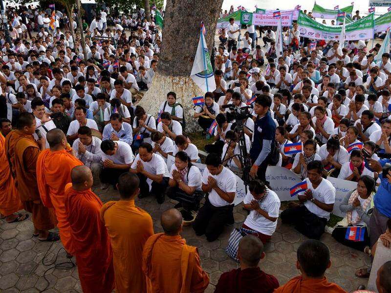 Buddhists monks bless workers during a gathering to mark International Labour Day in Phnom Penh on May 1, 2019.  TANG CHHIN Sothy / AFP