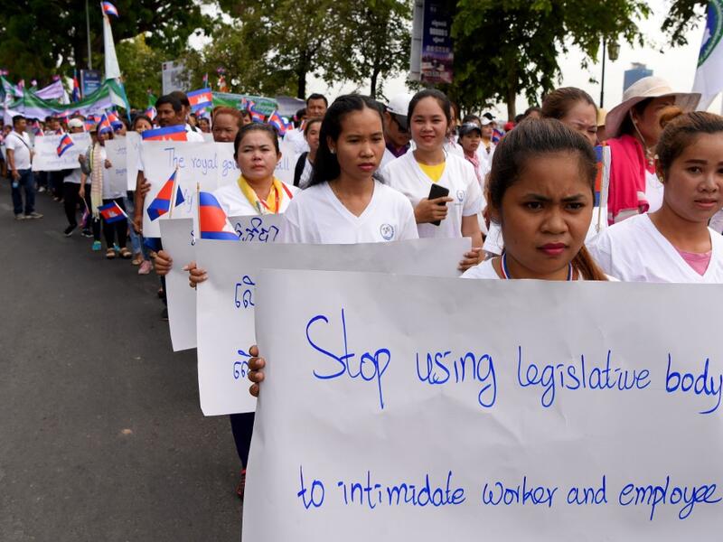 Workers march along a street to mark International Labour Day in Phnom Penh on May 1, 2019.  TANG CHHIN Sothy / AFP