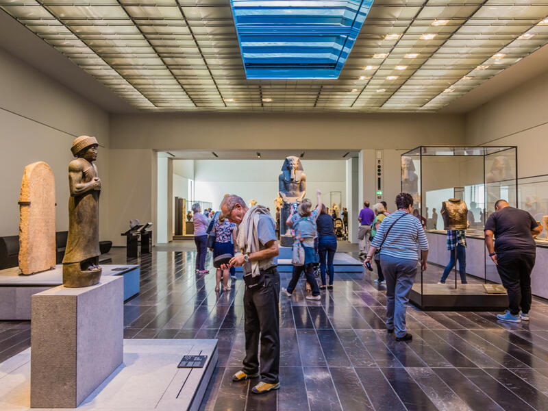 The Louvre. Visitors looking at exhibits in the 2nd Gallery of the Louvre, dedicated to The First Great Powers. (Shutterstock/ File Photo)