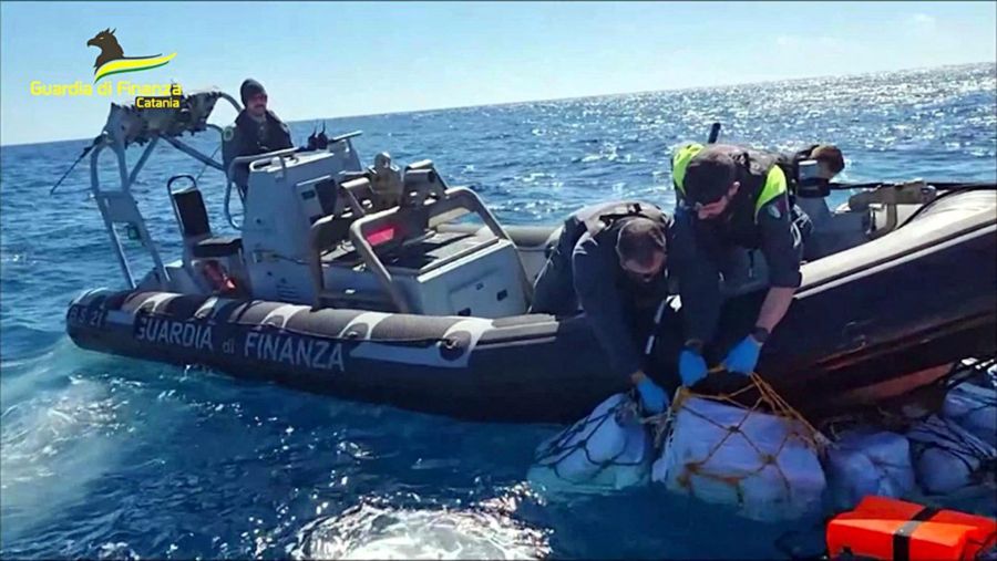 Italian narcotics police seizing drugs
