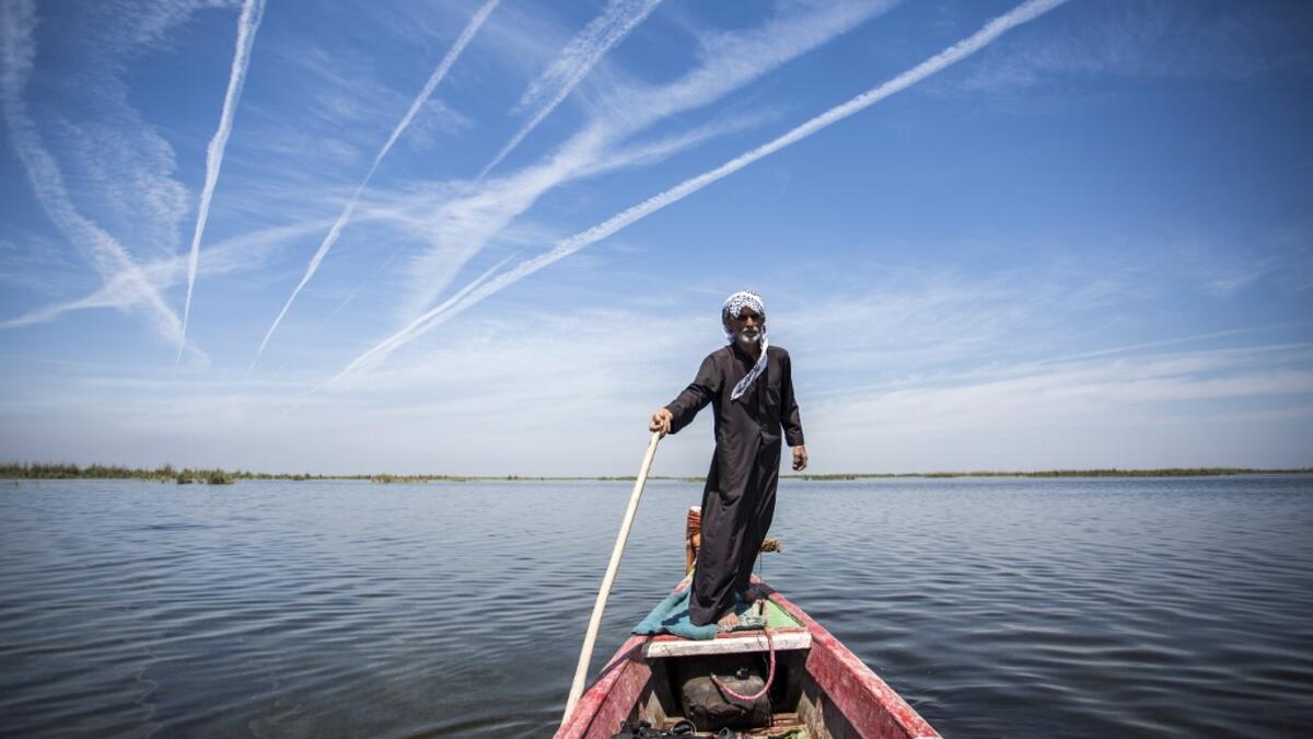 Abu Hayder, an Iraqi ecotourism guide, navigates a canoe in the marshes of the southern district of Chibayish in Dhi Qar province, about 120 kilometres northwest of the southern city of Basra, on March 29, 2019. Hussein FALEH / AFP