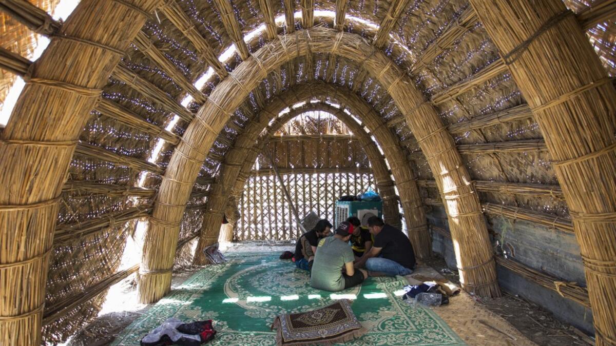 Tourists sitting inside a floating palm reed-woven house in the marshes of the southern Iraqi district of Chibayish in Dhi Qar province, about 120 kilometres northwest of the southern city of Basra. Hussein FALEH / AFP