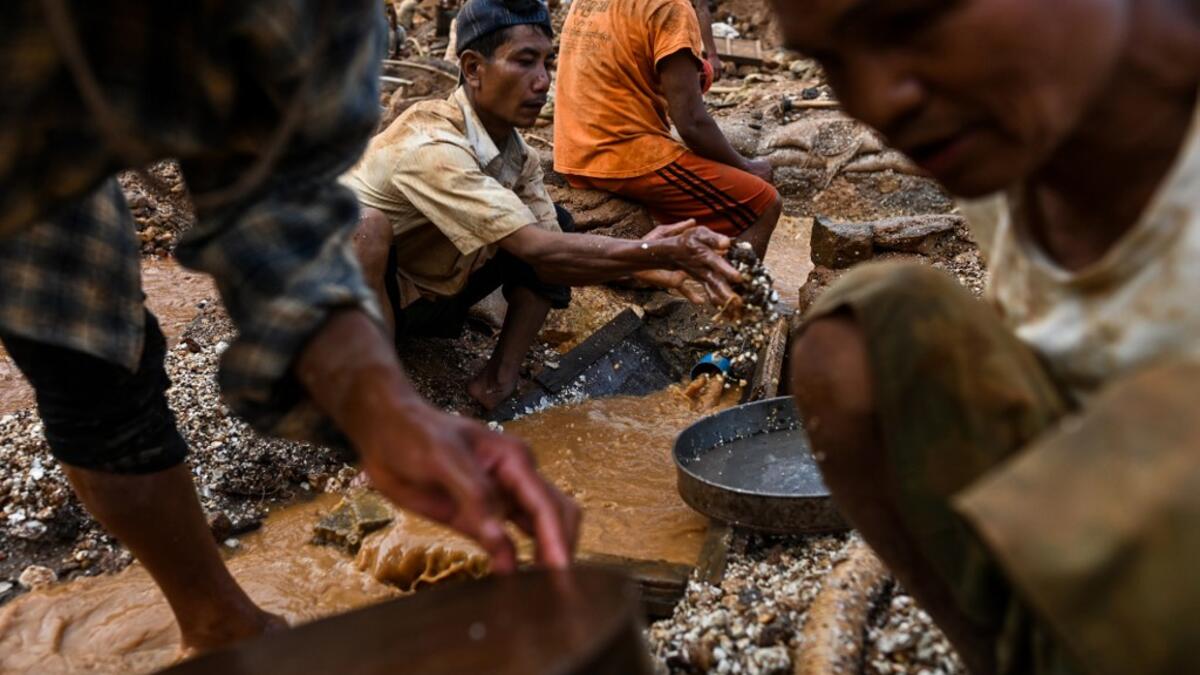 This photo taken on May 16, 2019 shows miners panning for rubies and other gemstones in a ruby mine in Mogok, north of Mandalay. Burrowing deep underground, thousands of informal miners risk their lives to find gleaming red gems as a law change spurs opportunity in Myanmar's "land of rubies". Ye Aung THU / AFP