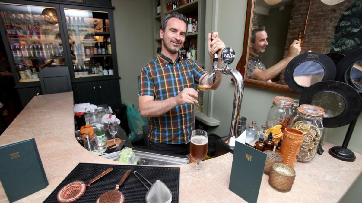 Pub co-owner Oisin Davis poses at the Virgin Mary pub, which opened recently selling non-alcoholic drinks and is known as the 'pub with no beer', in the city centre of Dublin on May 16, 2019. PAUL FAITH / AFP