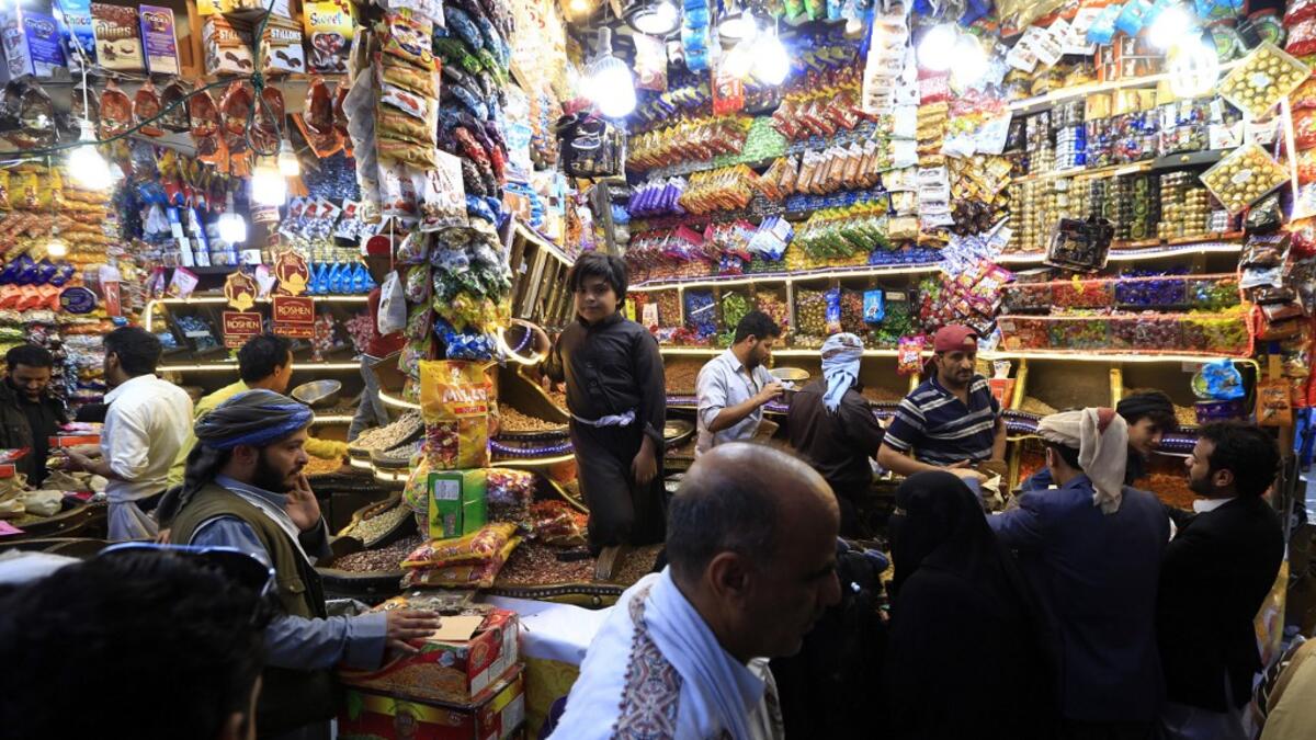 Yemenis shop for sweets and dried fruits in the capital Sanaa on May 28, 2019, during the holy Muslim month of Ramadan and ahead of Eid al-Fitr celebrations.  Mohammed HUWAIS / AFP