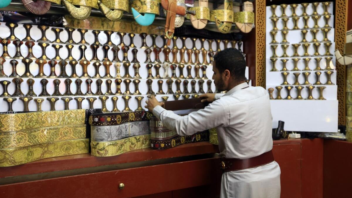 A Yemeni vendor displays "janbiyas", traditionally-worn short curved daggers, in Sanaa on May 28, 2019 during the holy Muslim month of Ramadan and ahead of Eid al-Fitr celebrations.  Mohammed HUWAIS / AFP