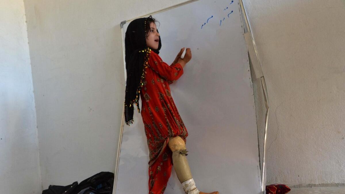 As 10 children from the same family were walking to school last year, they came across an unexploded mortar bomb - a common sight in Afghanistan, where war still rages between the Taliban and US-backed national forces. NOORULLAH SHIRZADA / AFP