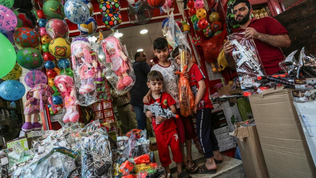 A Palestinian vendor sells toys at a market ahead of Eid al-Fitr holiday, celebrating the end of the holy Muslim fasting month of Ramadan, in Gaza City on June 2, 2019.  MAHMUD HAMS / AFP