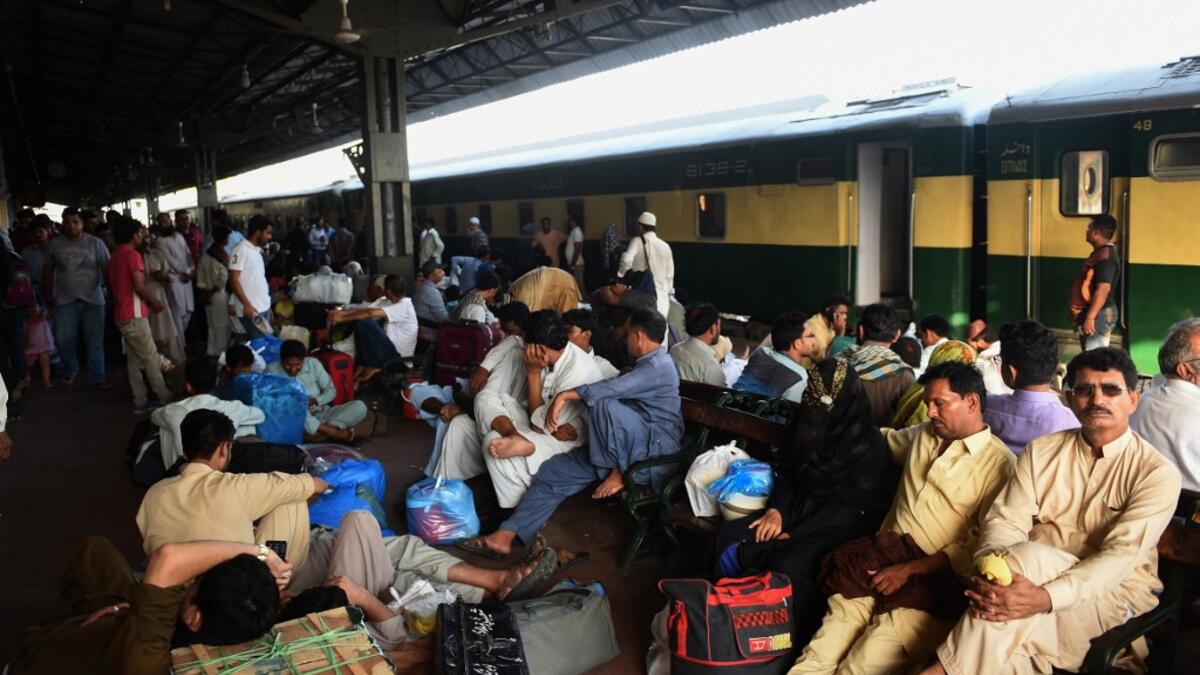 Pakistanis wait for the train to travel back home to be with their families ahead of the Muslim festival of Eid al-Fitr, in Karachi on June 2, 2019. RIZWAN TABASSUM / AFP