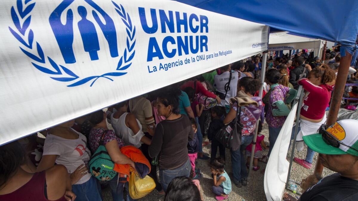 Venezuelan migrants arrive to get a refugee application at the Peruvian border post at the binational border attention centre (CEBAF) in Tumbes, Peru on June 14, 2019. (Cris BOURONCLE / AFP)