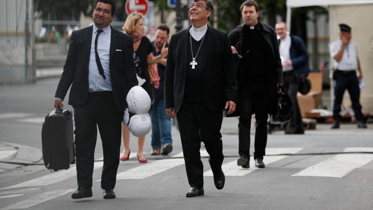 Archbishop of Paris Michel Aupetit (C) arrives to hold the first mass of the Notre-Dame de Paris cathedral two months after the fire, on June 15, 2019 in Paris. The Notre-Dame cathedral in Paris will host its first mass on June 15, 2019. Zakaria ABDELKAFI / AFP