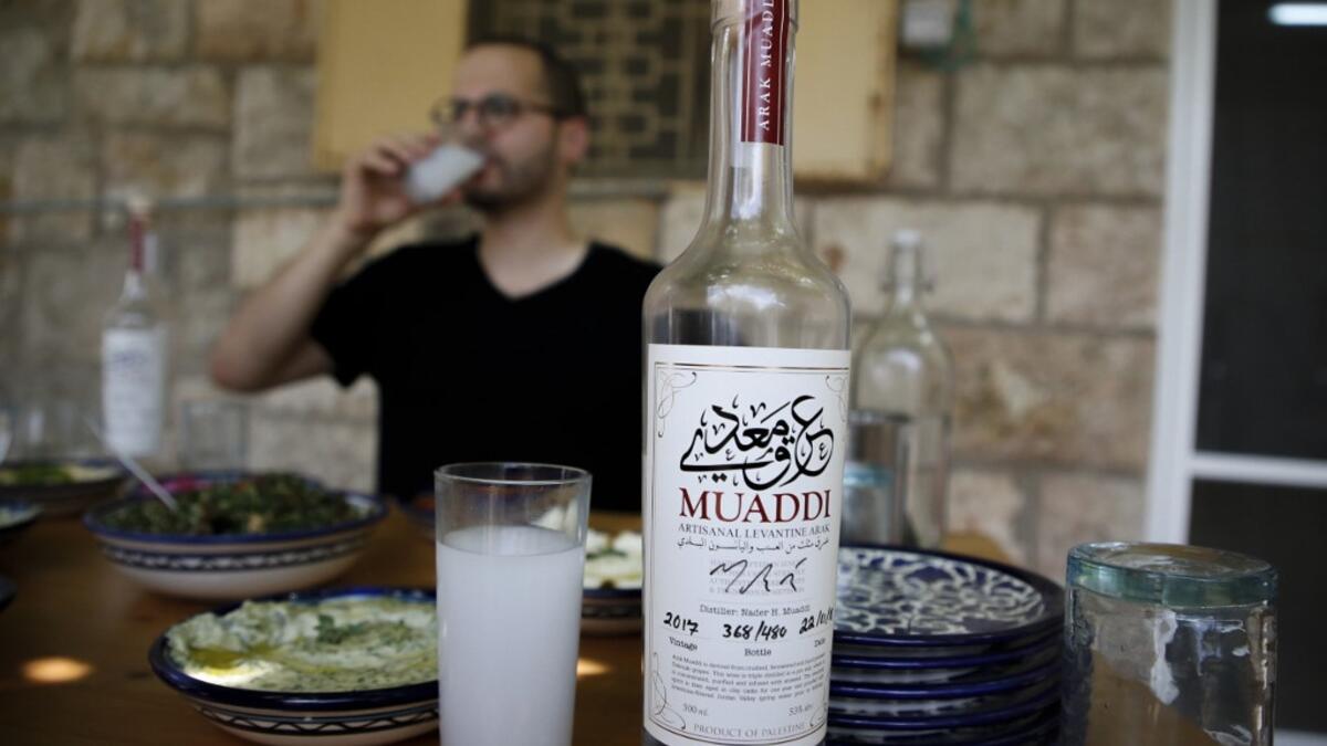 Palestinian distiller Nader Muaddi drinks his handcrafted Arak in the occupied West Bank city of Beit Jala, near Bethlehem, on June 16, 2019. In his basement, distiller Muaddi made fewer than 500 bottles of liquor last year, but it is earning global acclaim and reviving interest in the Palestinian alcohol sector. On the outskirts of the city famed for Jesus's birth, the 35-year-old illustrates the handcrafted way he makes Arak, an anise-flavoured drink popular in the Middle East and similar to Greek Ouzo, F
