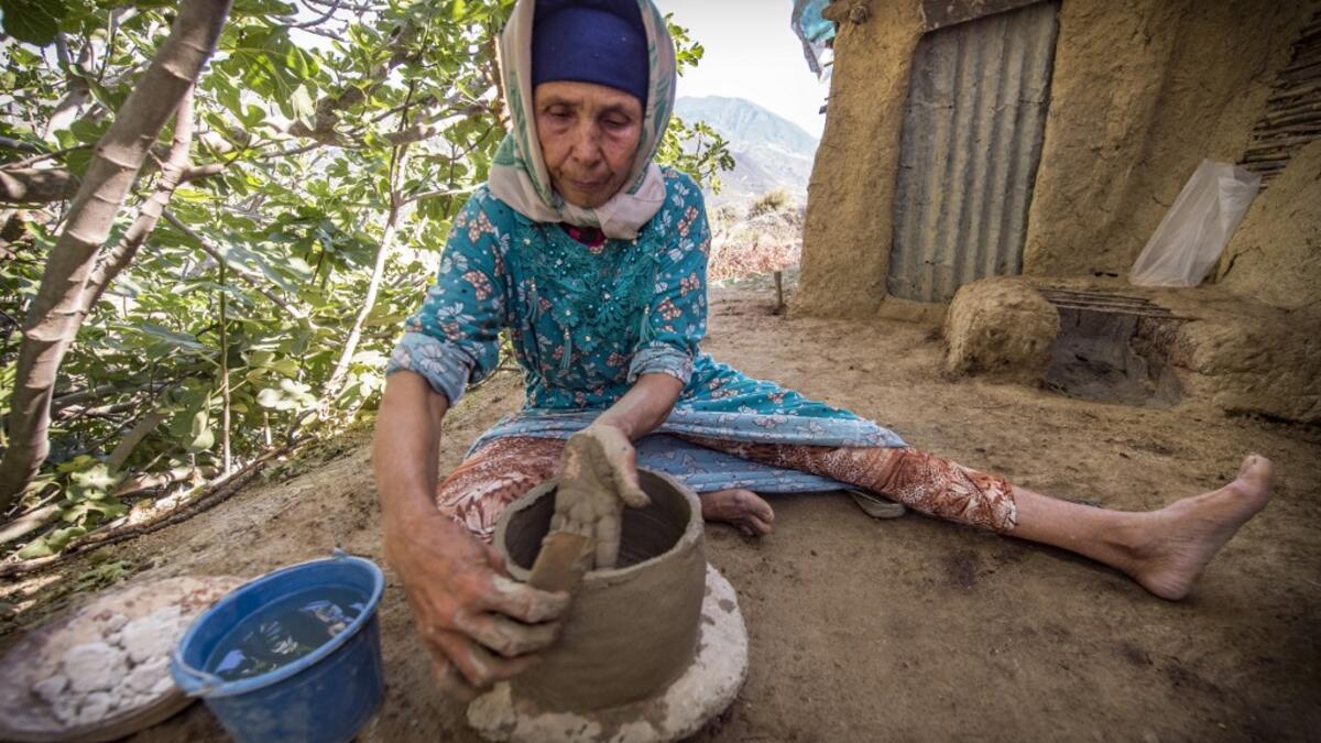 Moroccan potter Fatima Harama from the M'tioua tribe works on pottery near the village of Ourtzagh in the region of Taounate on june 11, 2019 The Sumano association, which promotes Moroccan tribal women's handicrafts, places orders with the potters, buys the works, transports them to Spain and sells them at 20 times the local price on its website, promising to redistribute the income locally "when the business becomes profitable". FADEL SENNA / AFP