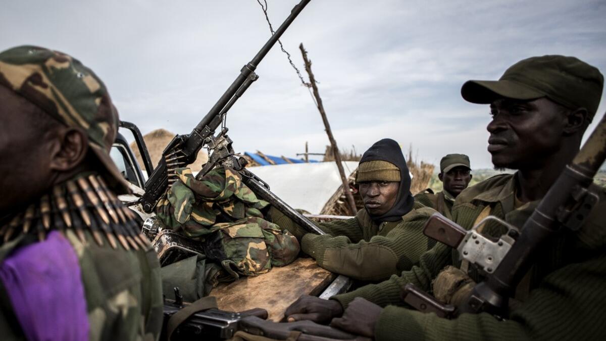 Soldiers of the Armed Forces of the Democratic Republic of the Congo (FARDC) sit in a truck bed in a base on July 3, 2019 in Djugu, eastern DR Congo. John WESSELS / AFP