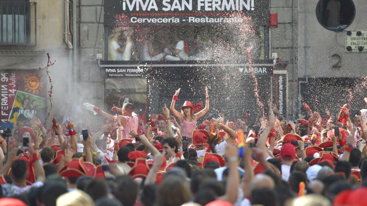 Revellers wait for the 'Chupinazo' (start rocket) to mark the kickoff at noon sharp of the San Fermin Festival, in front of the Town Hall of Pamplona, northern Spain, on July 6, 2019.  ANDER GILLENEA / AFP