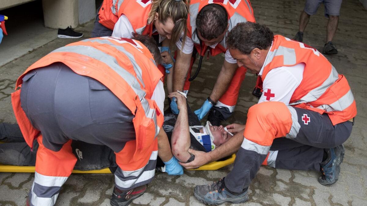 A participant receives medical assistance during the first bull-run of the San Fermin festival in Pamplona, northern Spain on July 7, 2019. JAIME REINA / AFP