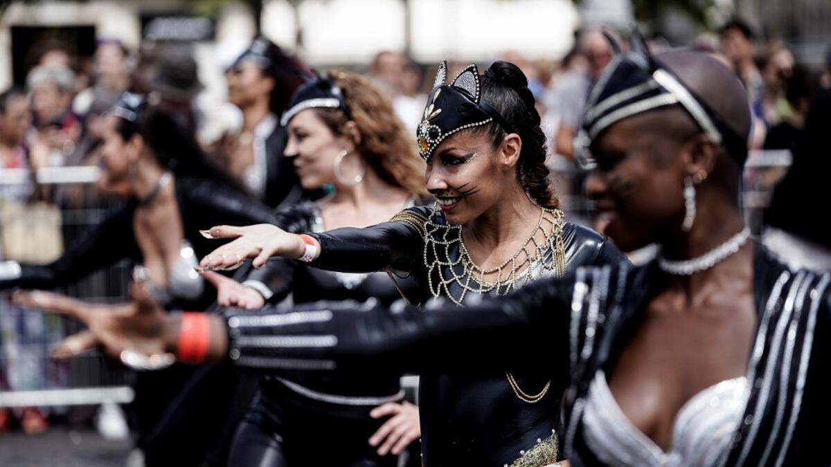 People parade during the Tropical Carnival on July, 7 2019 in Paris.  Kenzo TRIBOUILLARD / AFP