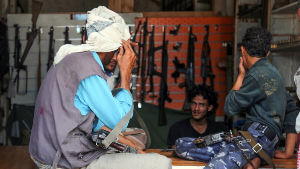 Armed men shop in Yemen's third city of Taez, on July 13, 2019. Before the war, the old market of Taez was crowded with people and full of handcrafts and artisanal goods. Today, more than four years after the Huthi rebels began their siege on Yemen's third largest city, bullets and guns have taken over the market. AHMAD AL-BASHA / AFP