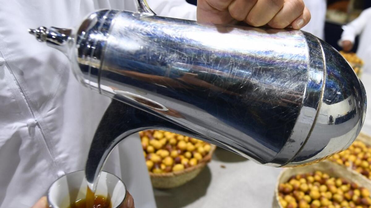 An Emirati man pours coffee during the annual Liwa Date Festival in the western region of Liwa on July 17, 2019. Karim SAHIB / AFP