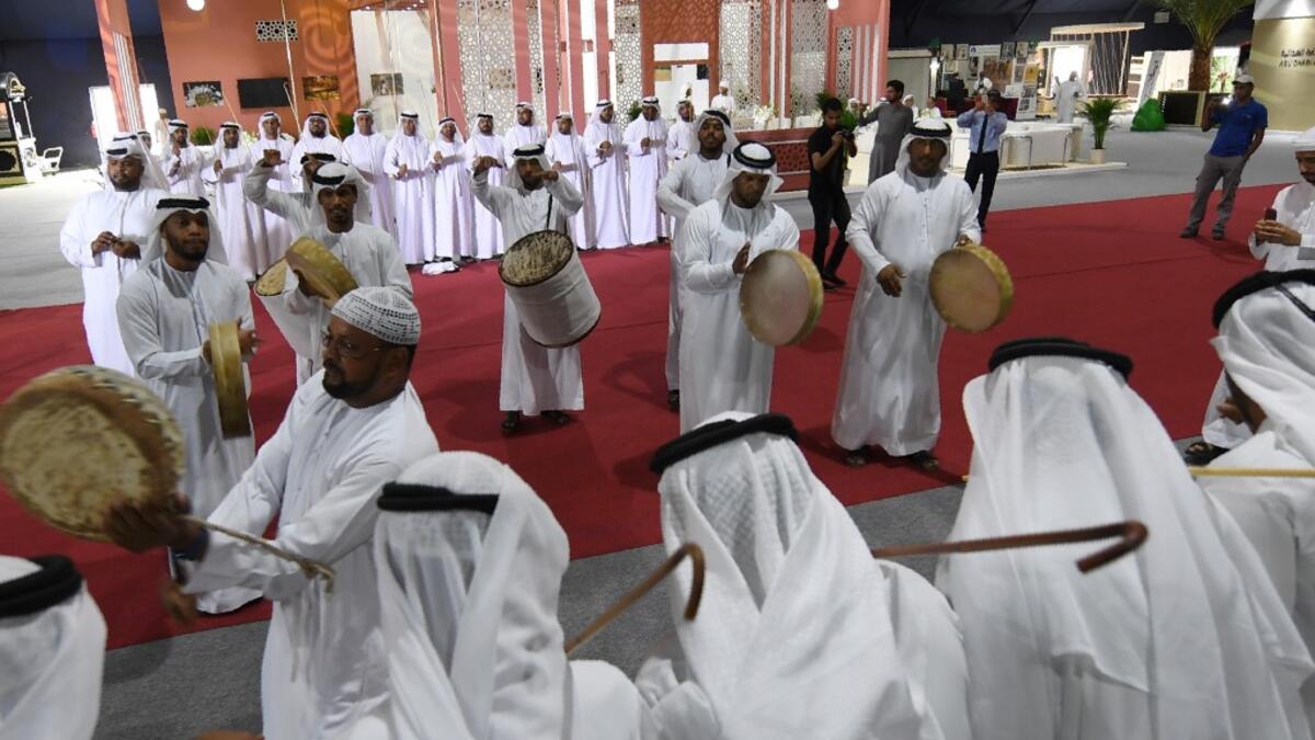 Emirati musicians perform during the annual Liwa Date Festival in the western region of Liwa on July 17, 2019. The Liwa Date Festival aims to preserve Emirati heritage, specifically palm trees and half-ripe dates, knows as "ratab", which are deep-rooted in the Gulf country's traditions. Karim SAHIB / AFP