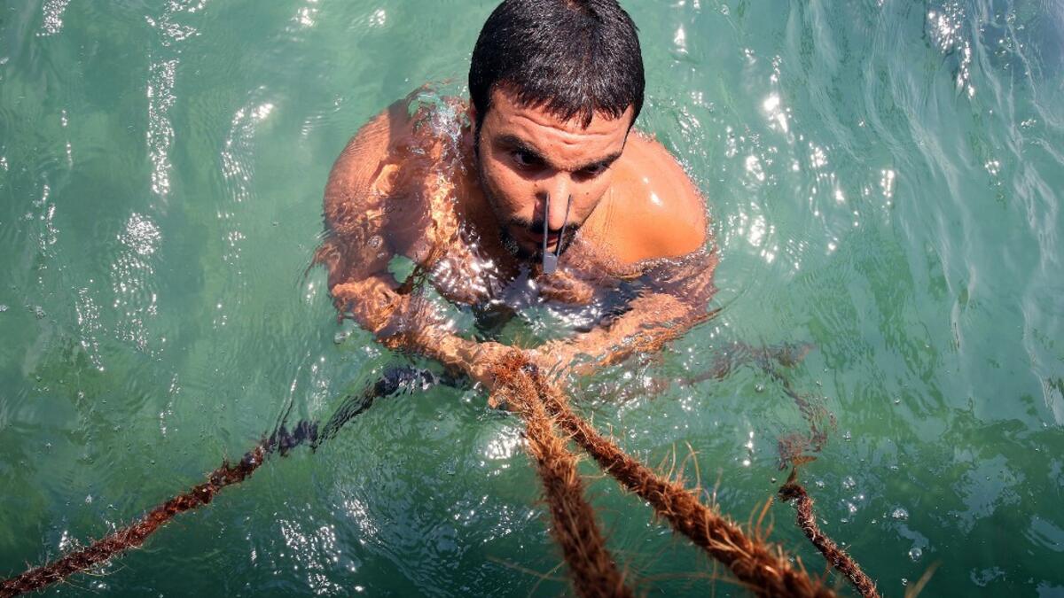 Pearl-diving trips are held annually under the patronage of the Kuwaiti emir in order to keep alive traditions that accompanied the once important national trade of pearl diving, prior to the discovery of oil. Yasser Al-Zayyat / AFP