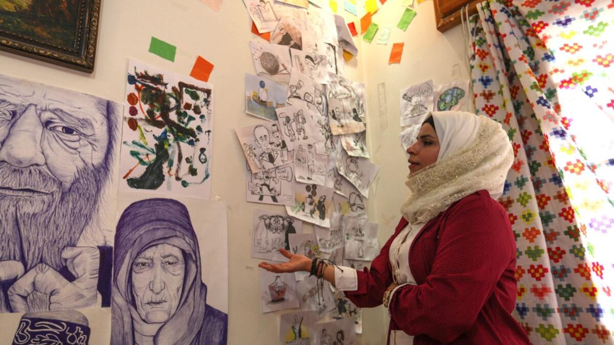 In war-torn northwest Syria, cartoonist Amani al-Ali takes her pen to the screen to sketch life in the embattled opposition bastion of Idlib.  Omar HAJ KADOUR / AFP