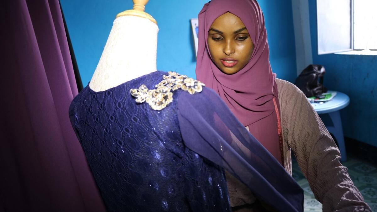 Hawa Adan Hassan, a 23 year-old university student and a young Somali female fashion designer checks her new finished fashion design, on November 3, 2018, in Mogadishu. Abdi HAJJI HUSSEIN / AFP