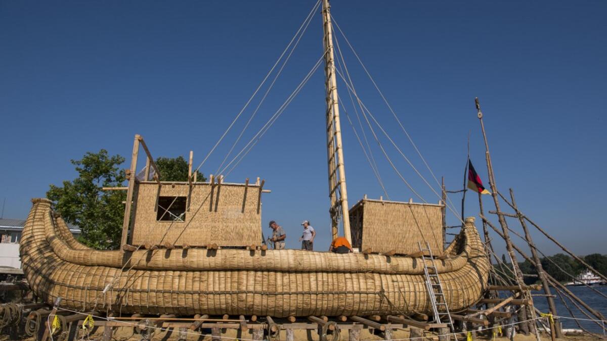 Members of the crew assemble the 14-meter long sailing reed boat Abora IV in the town of Beloslav, Bulgaria, on July 25, 2019. NIKOLAY DOYCHINOV / AFP