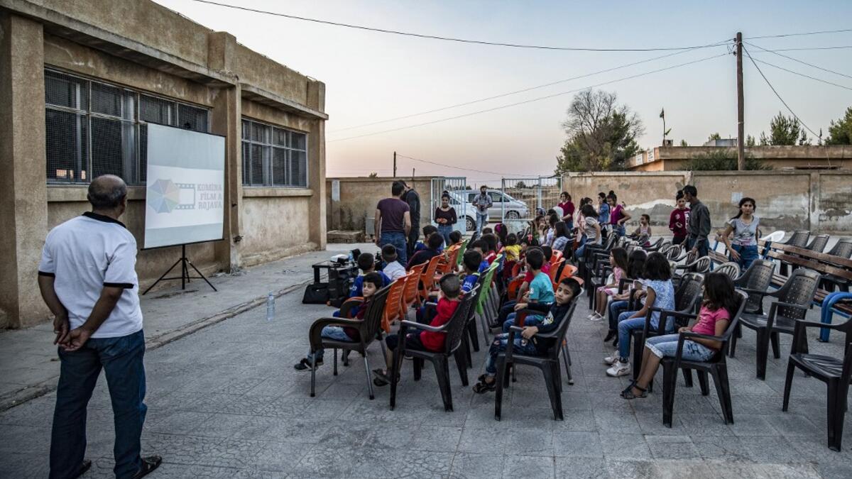 Hinde is screening films in remote villages using just a laptop, projector and a canvas screen. With some films dubbed into Kurdish and others subtitled, he and a team of volunteers want to spread their love of cinema across Rojava, the Kurdish name of the semi-autonomous northeast of war-torn Syria. DELIL SOULEIMAN / AFP