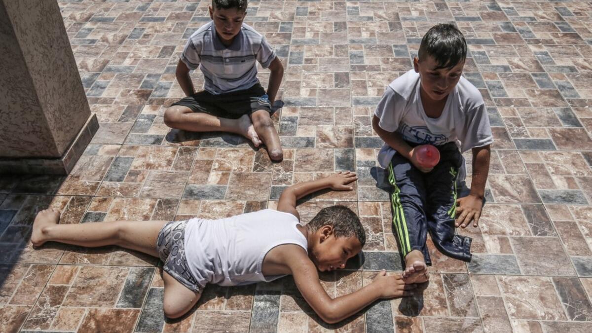 Palestinian amputee children rest during a summer camp origanized by the Palestinian Children's Relief Fund (PCRF) in the town of Khan Yunis in the southern Gaza strip on August 3, 2019. The PCRF is a non-governmental organisation providing physical and psychological services for disabled children in Gaza Strip. SAID KHATIB / AFP