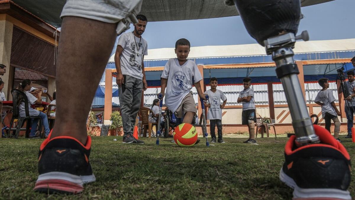 Palestinian amputee children play football during a summer camp origanized by the Palestinian Children's Relief Fund (PCRF) in the town of Khan Yunis in the southern Gaza strip on August 3, 2019.  SAID KHATIB / AFP