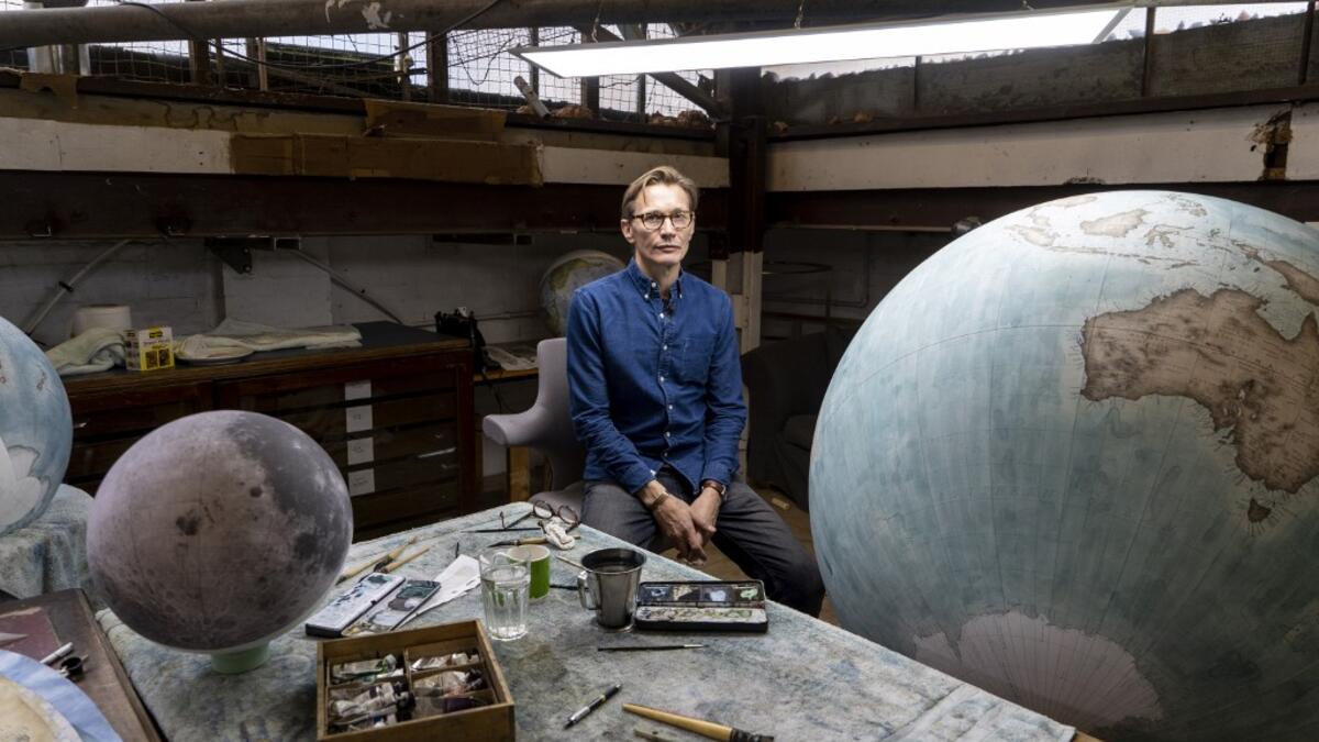 Artisan globemaker, Peter Bellerby poses for a photograph at the Bellerby and Co Globemakers' workshop and headquarters in Stoke Newington in north London, on July 19, 2019. Niklas HALLE'N / AFP