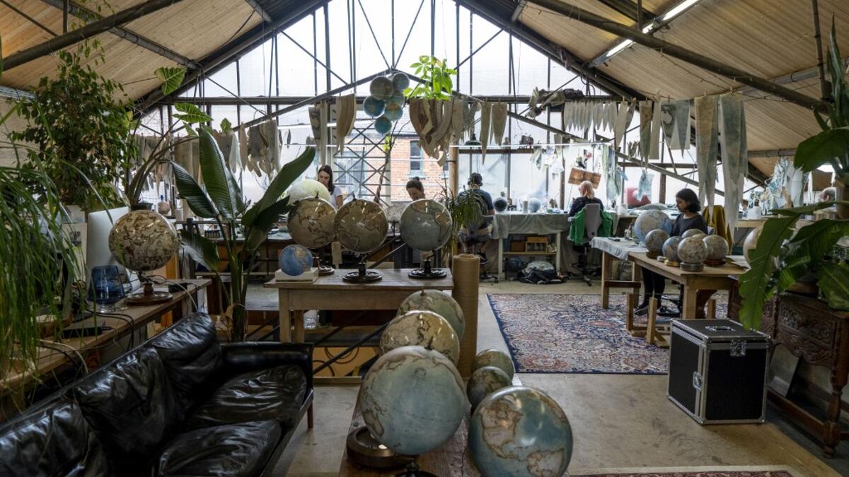 Artisan globemakers are pictured at work at the Bellerby and Co Globemakers' workshop and headquarters in Stoke Newington in north London, on July 19, 2019. Niklas HALLE'N / AFP